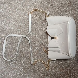 Grossi cream bow front pebble leather mini crossbody purse